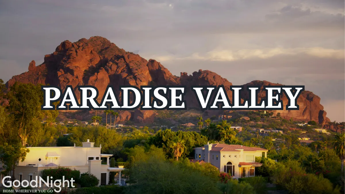This exterior image features mountains as a scenic backdrop to residential buildings surrounded by lush vegetation. The setting is serene, suggesting a tranquil and safe neighborhood ideal for families who value both comfort and the peace of nature.